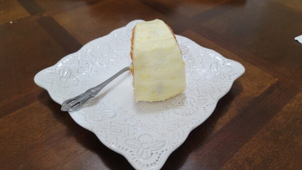 A piece of cake on top of a white plate.