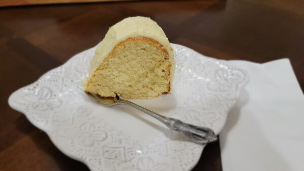 A piece of cake on top of a white plate.