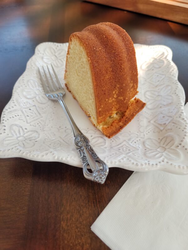 A piece of cake on top of a white plate.