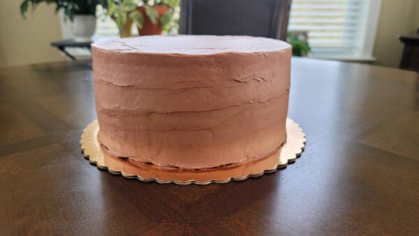 A cake sitting on top of a wooden table.