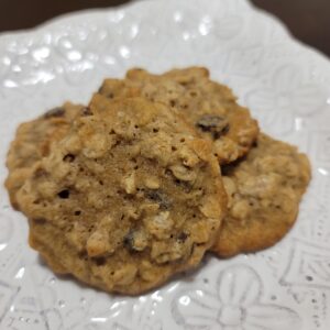 A white plate topped with three cookies on top of a table.