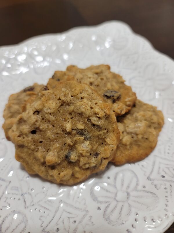 A white plate topped with three cookies on top of a table.