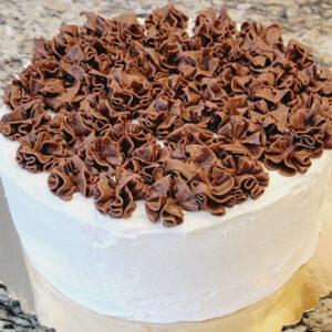 A white cake with chocolate frosting on top.