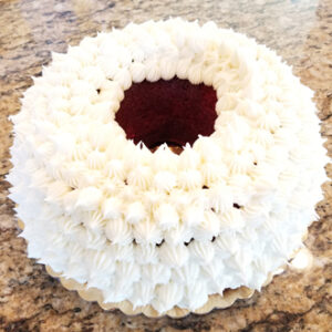 A cake that has been made with white frosting.