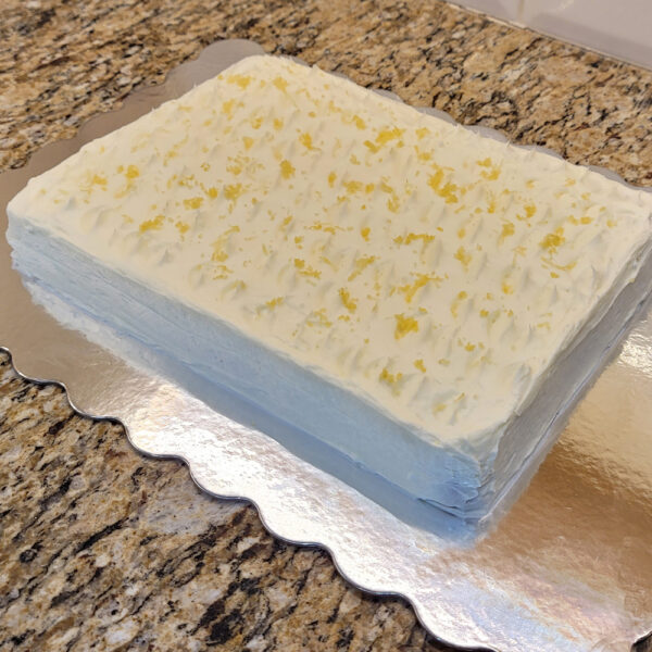 A cake sitting on top of a metal pan.