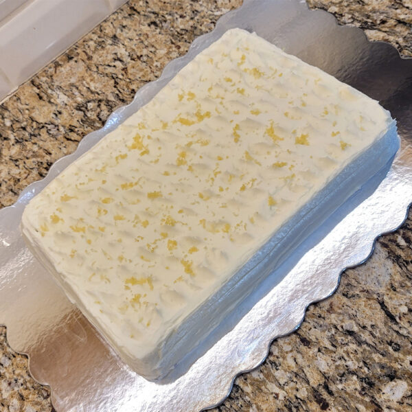 A cake sitting on top of a metal pan.