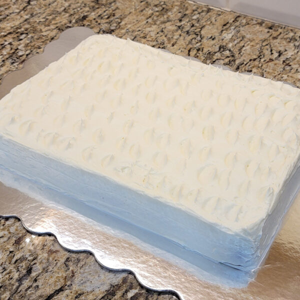 A cake sitting on top of a metal pan.