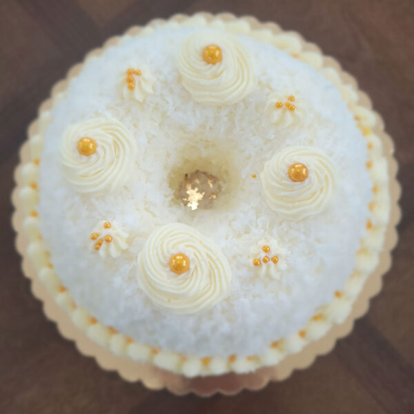 A white cake with yellow flowers on top of it.